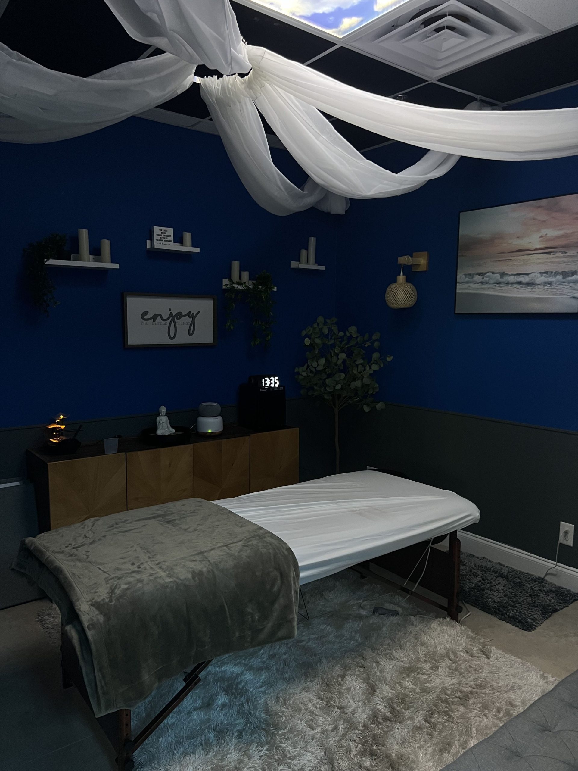 A massage table in a room with blue walls.