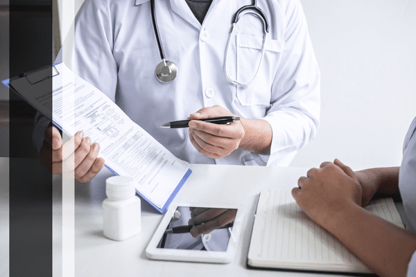 Doctor reviewing patient's medical form.