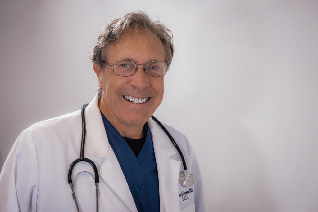 Smiling doctor in white coat and stethoscope.