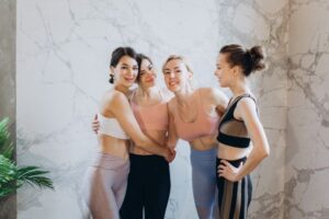 women hugging in fitness clothes