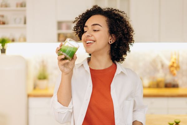 woman drinking green juice