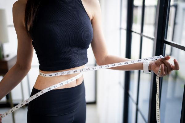 woman measuring waist